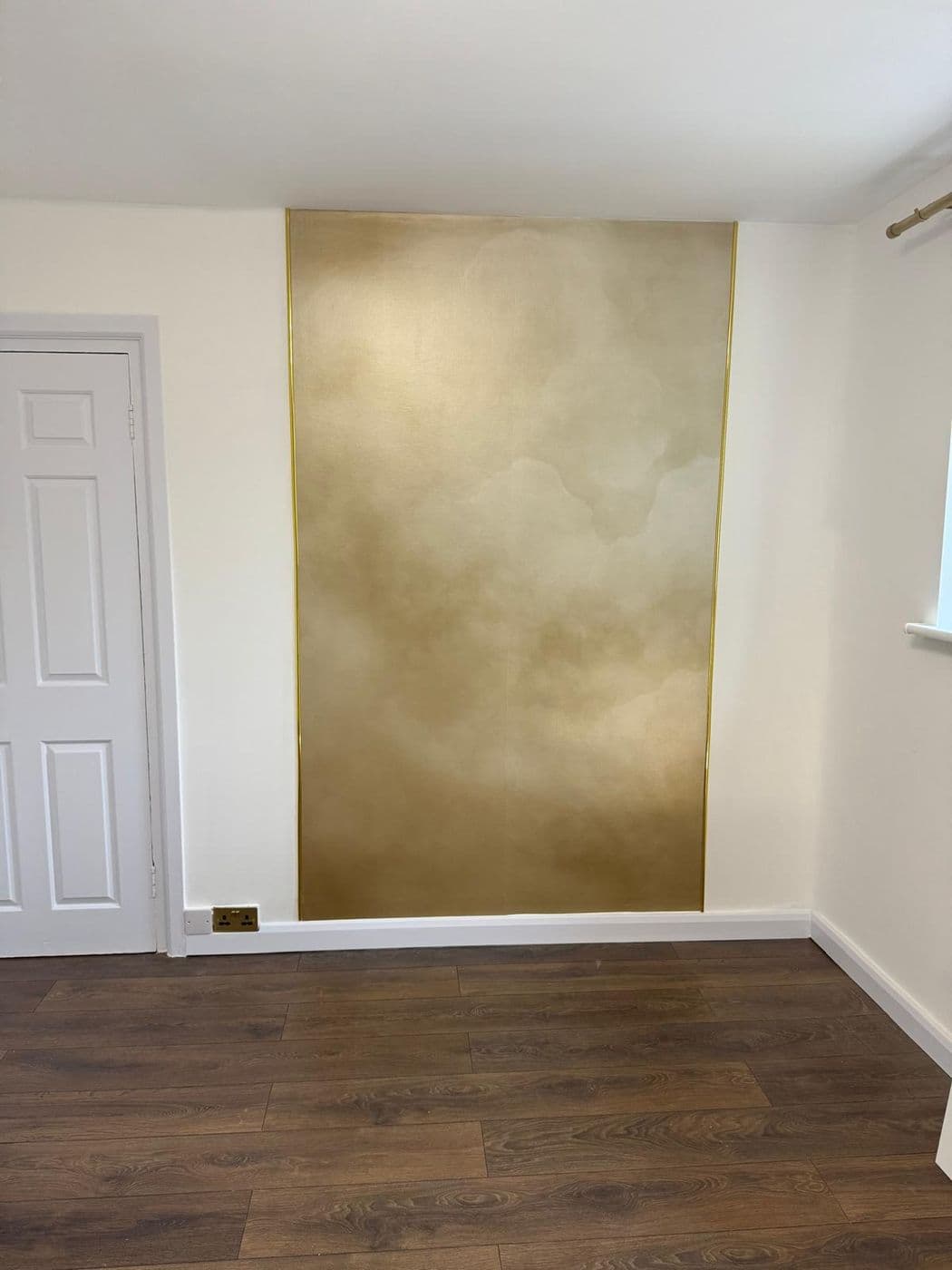 Freshly painted room mid-decoration with a stepladder and paint kettle
