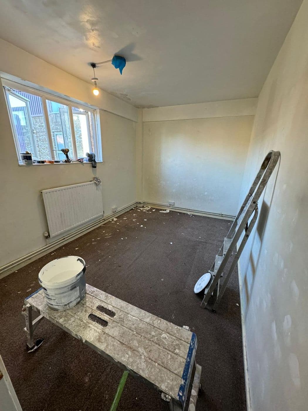 The bedroom before work, with bare floorboards and old carpet lifted