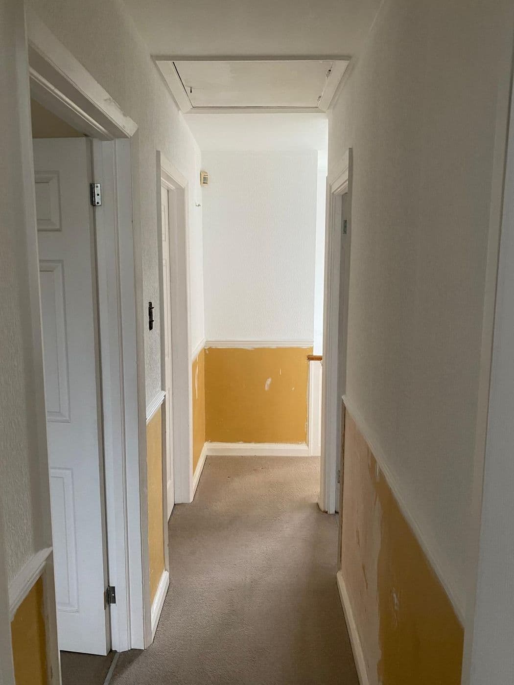 The hallway before work, with tired yellow paint below the dado rail
