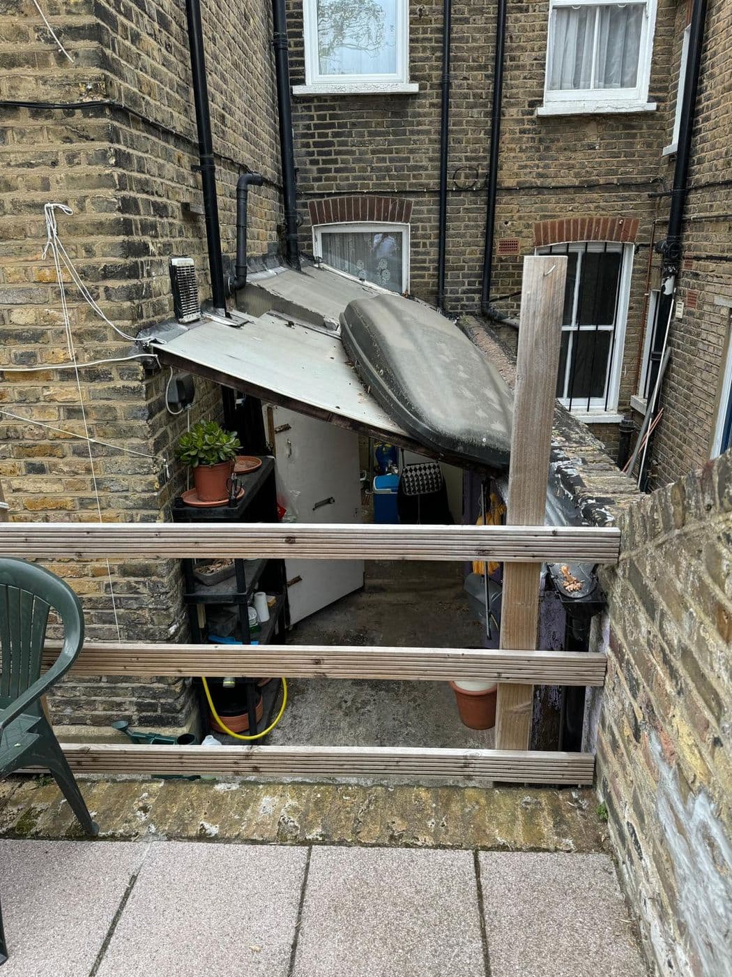 The old lean-to before work, with a sagging roof and failing timber